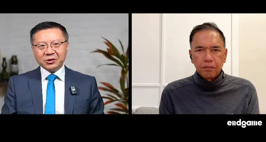 Dvaja muži v online diskusii: pán v obleku a pán v roláku.
